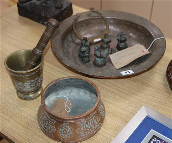 A group of mixed Eastern metalwares including pestle and mortar, weights, copper basin, etc. largest diameter 36cm